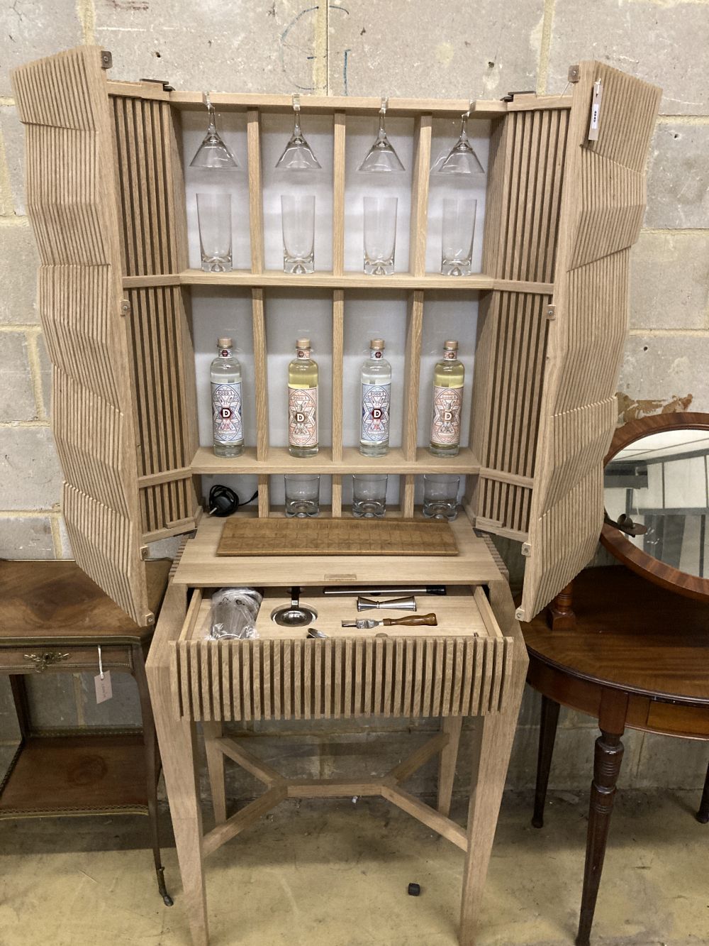 A Christopher Coane design British oak spirits cabinet, supplied with British spirits glassware and stainless steel accessories, width